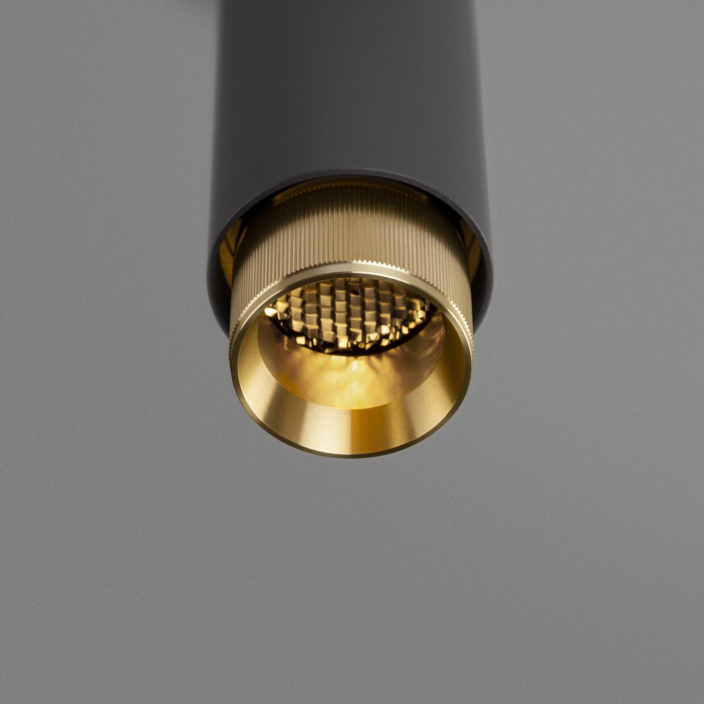 Exhaust Pendant Light / Linear / Graphite Brass, detailed close up view of kurling and light.