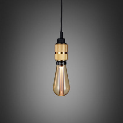 Hooked 1.0 Pendant Light / Nude Brass, close up view with gold bulb.