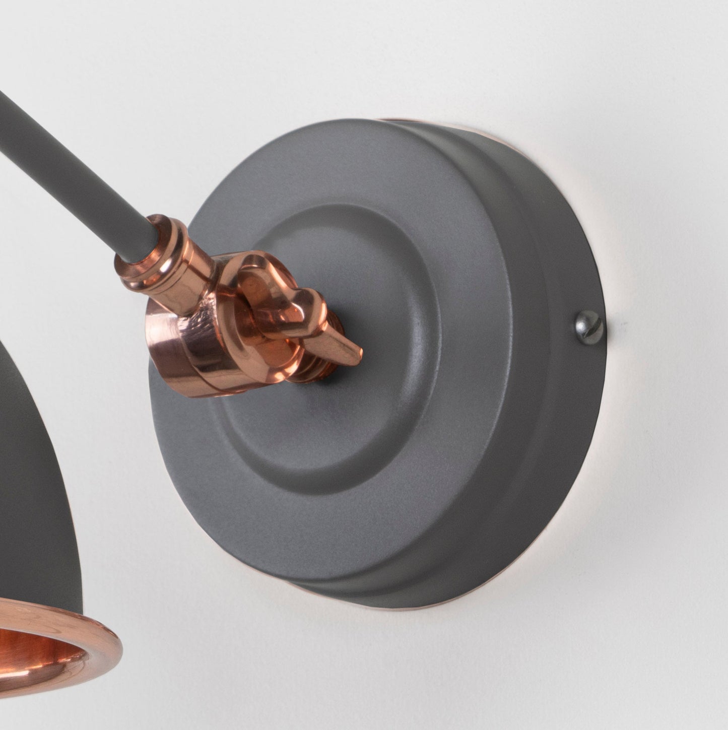 Smooth Copper Brindley Wall Light Bluff, close up view of fitting and cable.