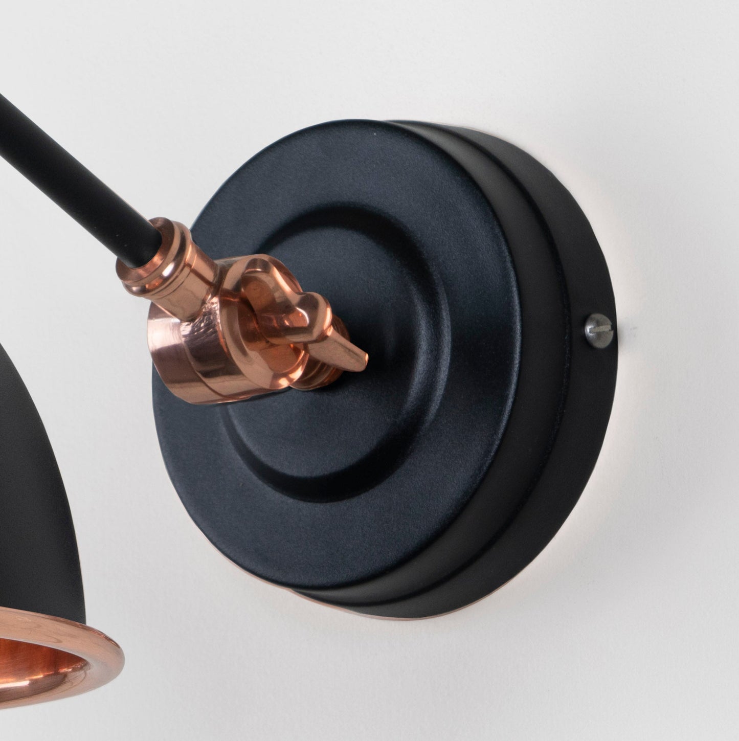Smooth Copper Brindley Wall Light Elan Black, close up view of fitting and cable.