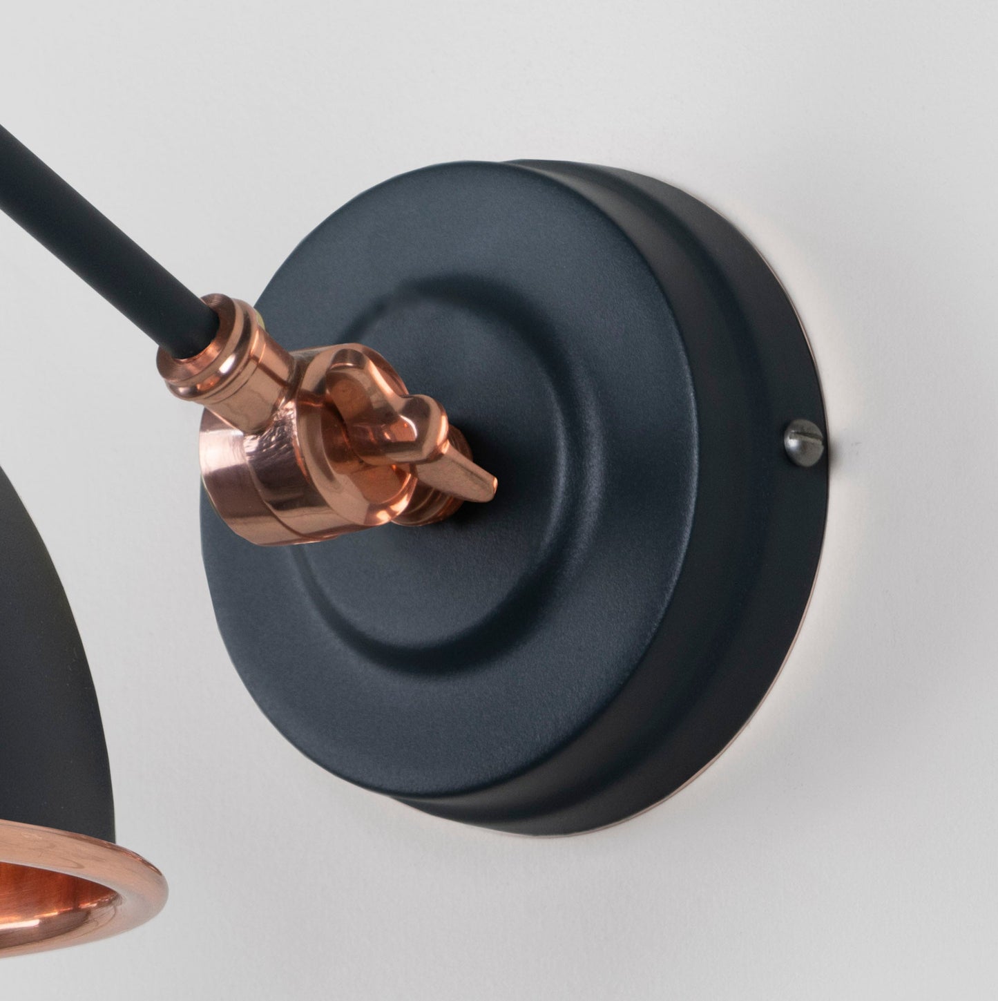 Smooth Copper Brindley Wall Light Soot, close up view of fitting and cable.