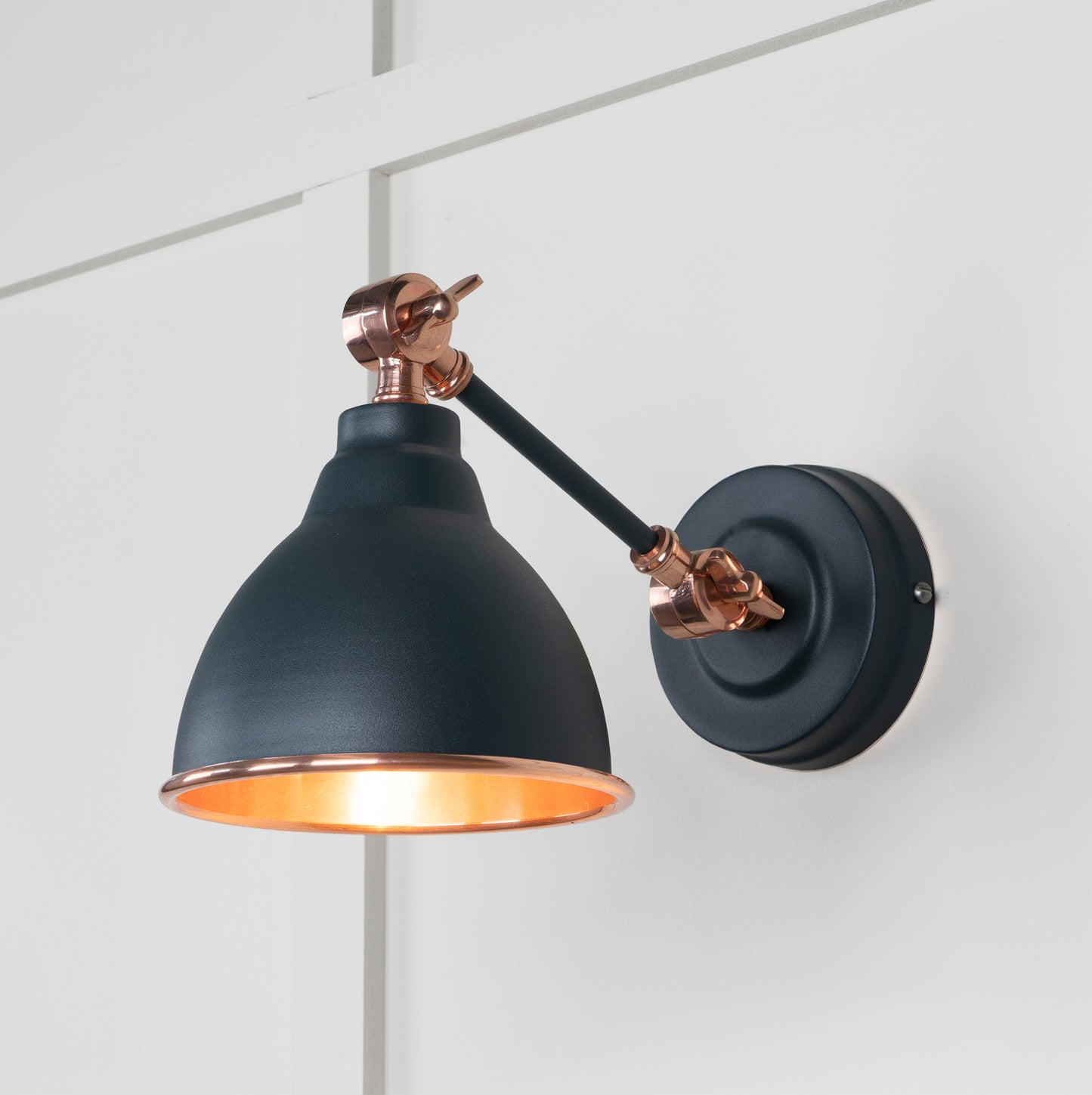 Smooth Copper Brindley Wall Light Soot, Front Side with light on.