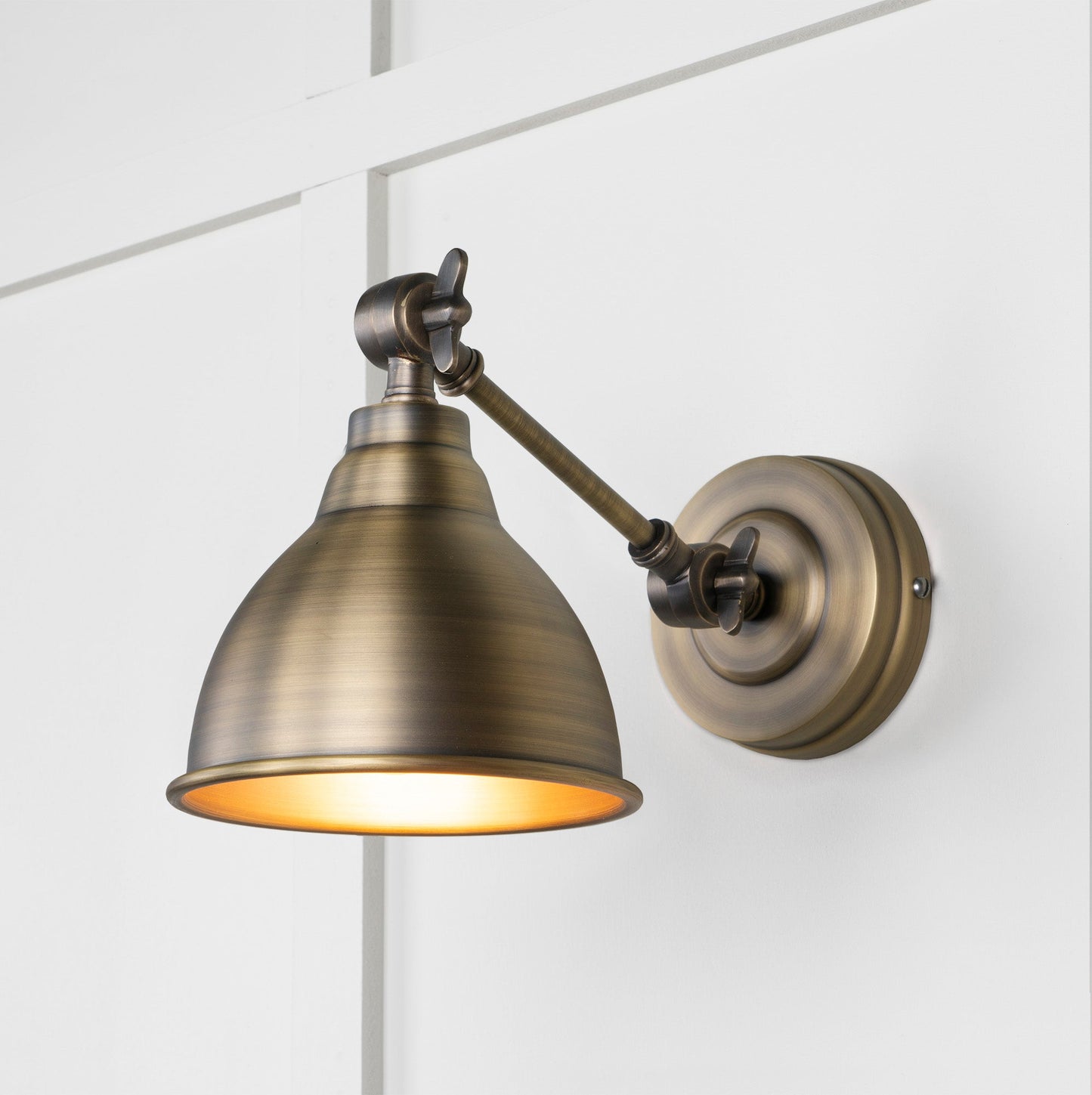 Aged Brass Brindley Wall Light , Front Side with light on.