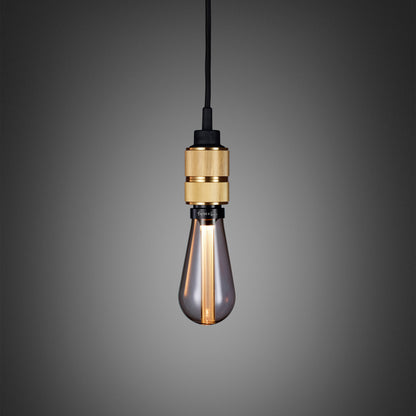 Hooked 1.0 Pendant Light / Nude Brass, close up view with smoked bulb.