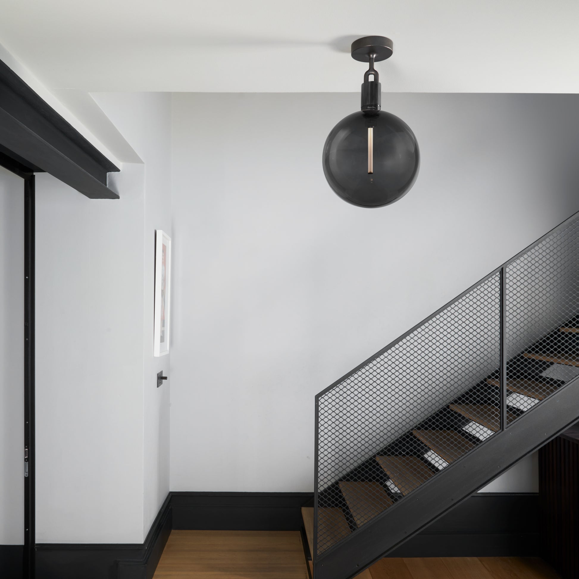 Forked Ceiling Light / Globe / Smoked / Large Gun Metal, on ceiling in hallway setting.