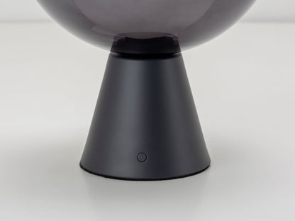 Charcoal grey rechargeable table lamp, detailed frontview of button.