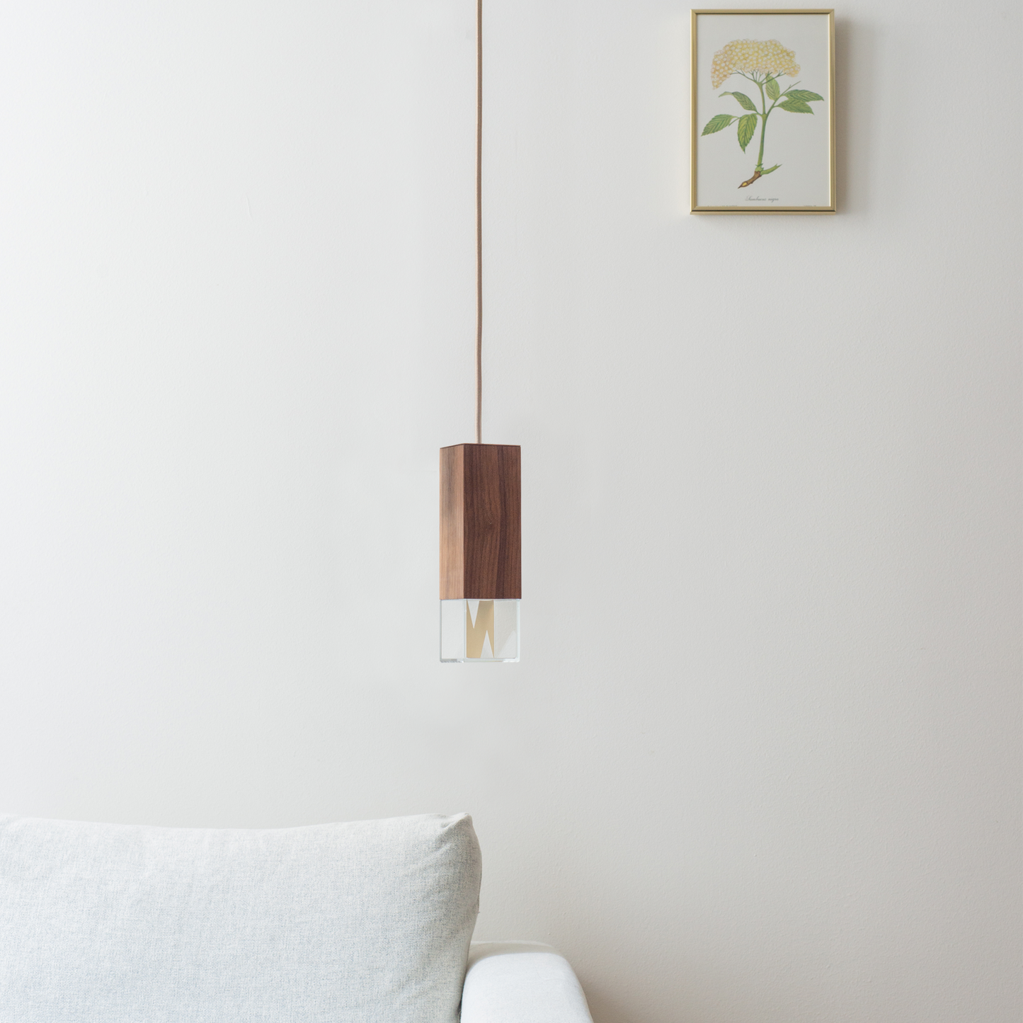 Lamp One Pendant Light / Wood, hanging from ceiling in living room setting.