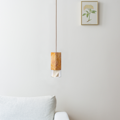 Lamp One Pendant Light / Yellow, light hanging from ceiling in living room setting.