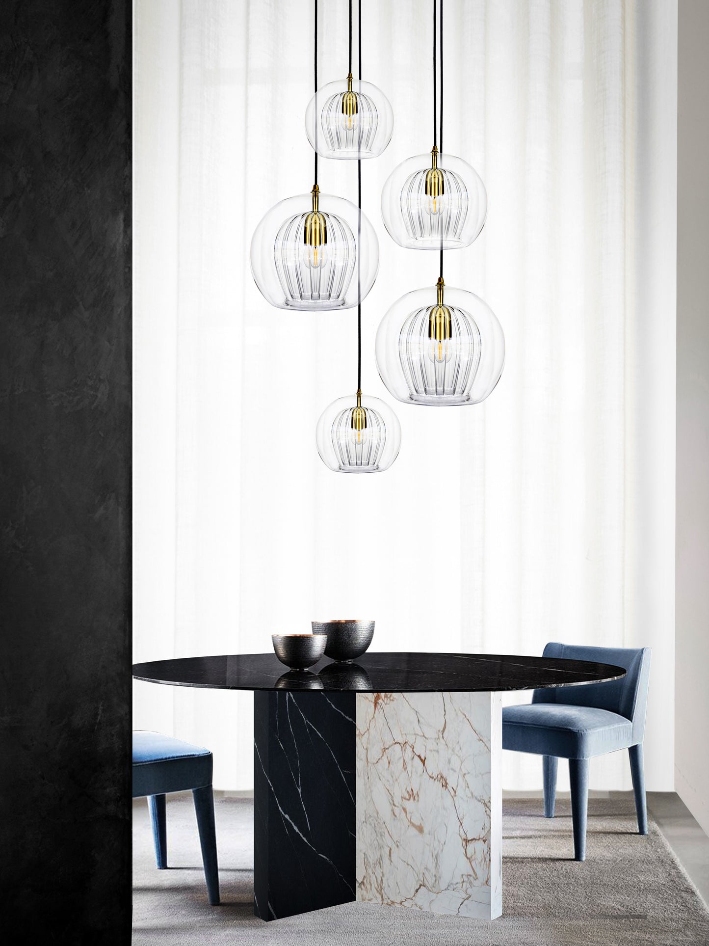 Pleated Crystal 5 Pendant Cluster Light clear, hanging from ceiling above table in setting..