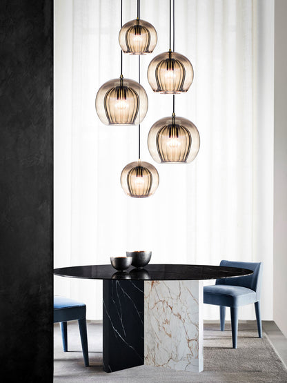 Pleated Crystal 5 Pendant Cluster Light smoked, hanging from ceiling above table in setting.