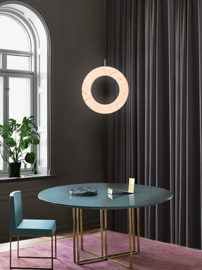 Rosa Ring Pendant Light, hanging from ceiling above table in setting.