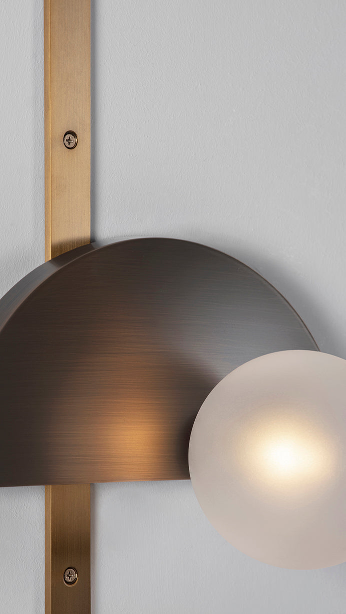 Exhibition Wall Light, close up of half moon and globe light on.