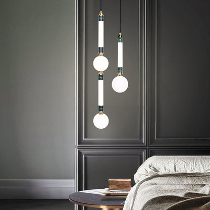 Greenstone Small Pendant Light, hanging from ceiling above bedside table.